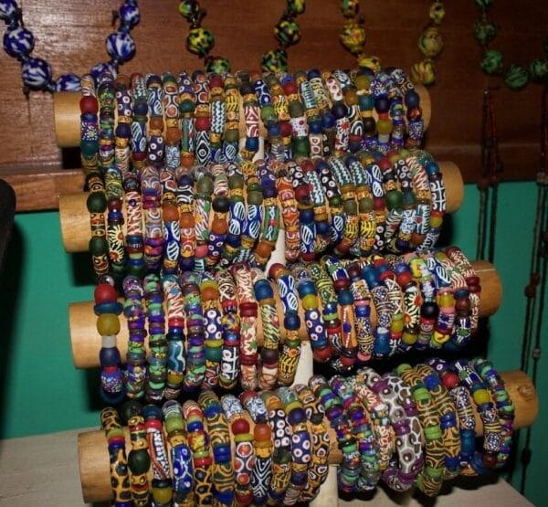 Handmade Ghanaian recycled-glass trade beads and necklaces on display at a craft stall