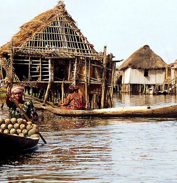 Thatched stilt houses and dugout canoes on the water at Ganvie lake village